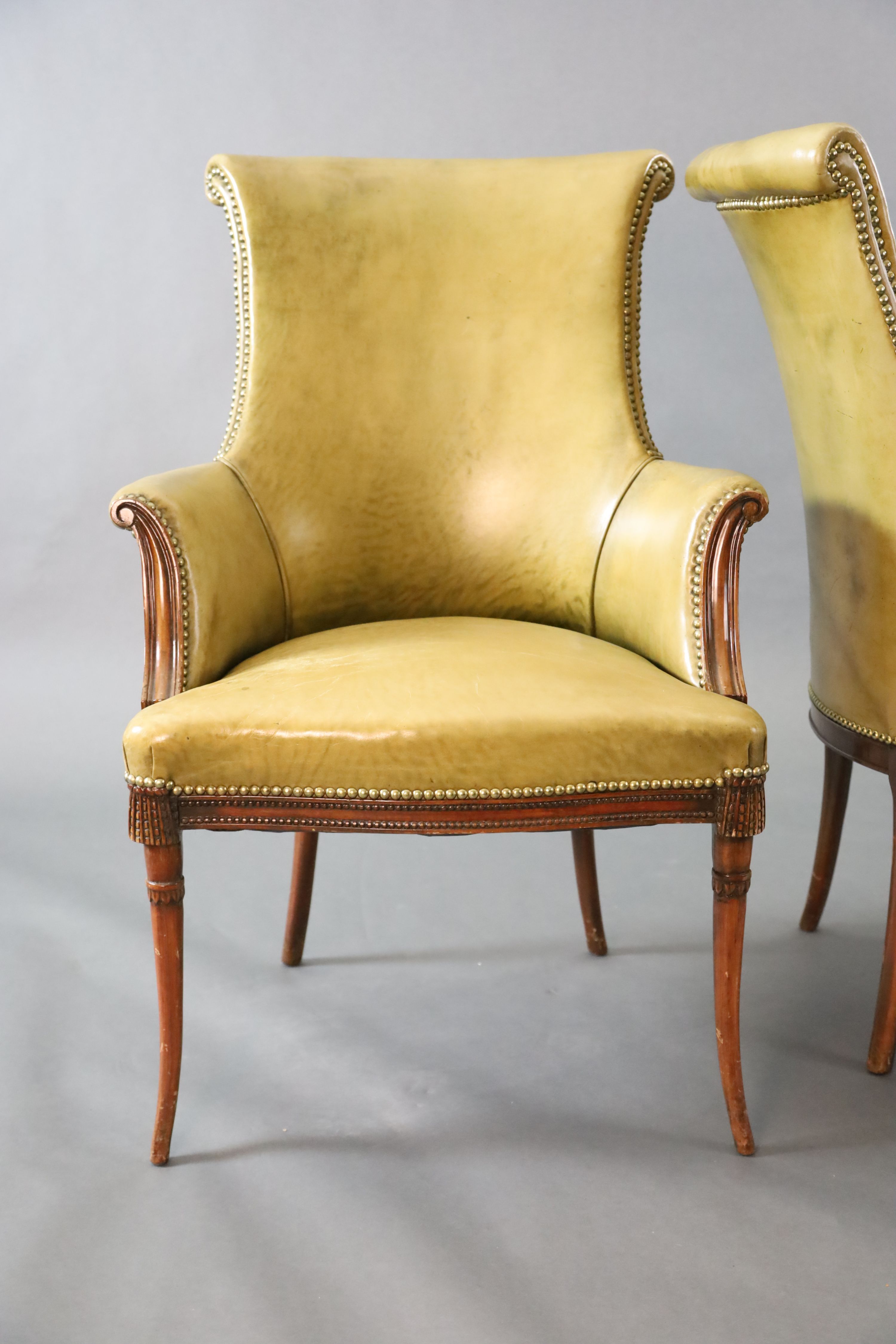 A pair of Regency style leather and mahogany library chairs, W.2ft 3in. D.2ft 3in. H.3ft 2in.